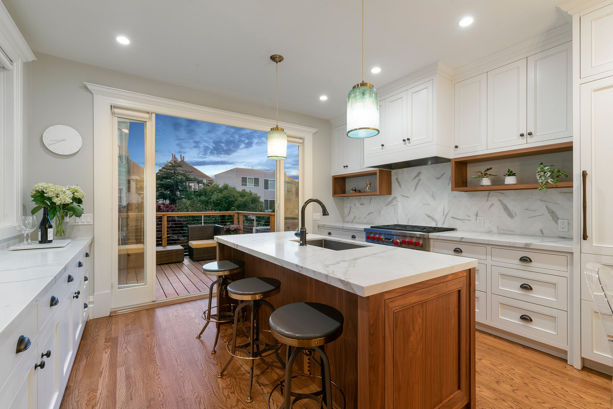Kitchen-with-patio View of a kitchen, featuring white cabinetry, center island, and patio
