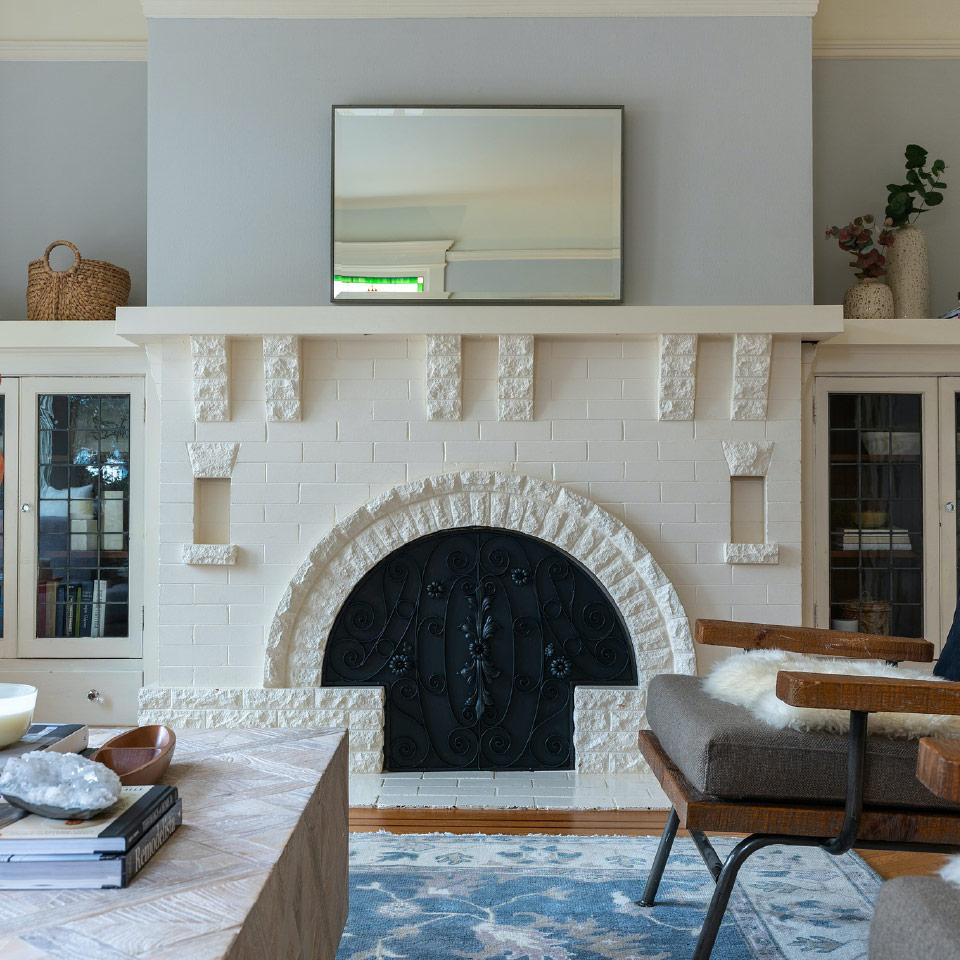 Brick-fireplace View of an ornate fireplace with white painted brick