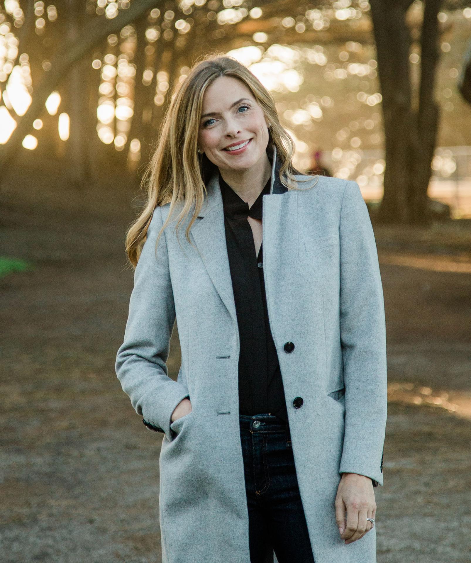 View of Shannon Hughes standing outdoors fearing a coat