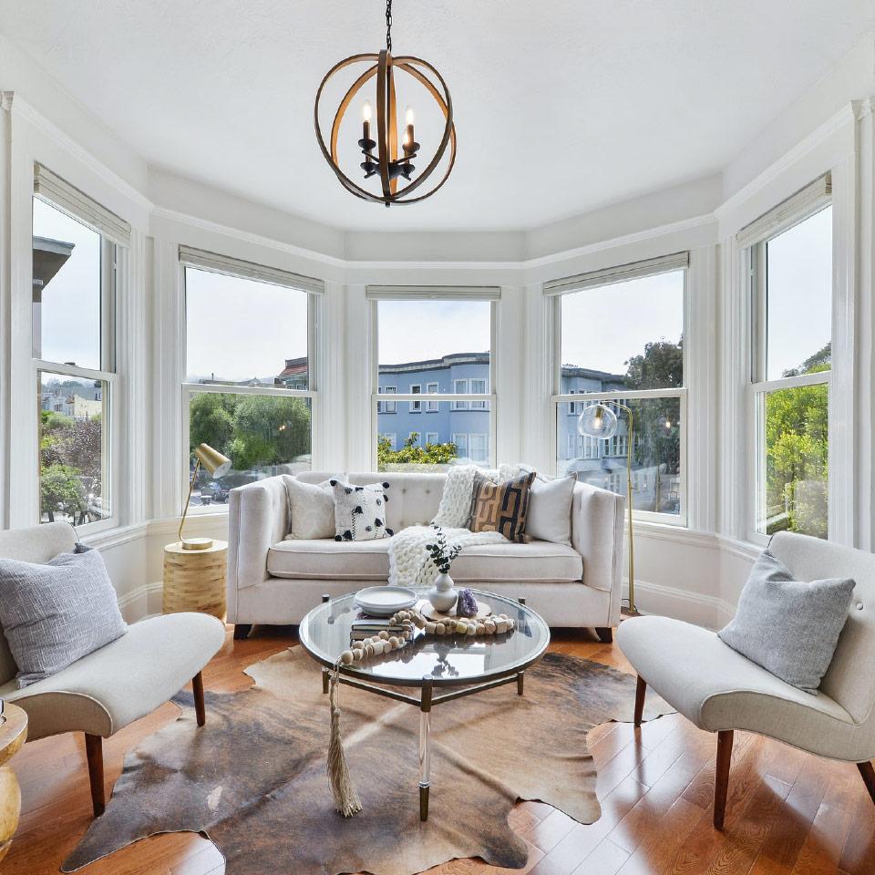 View of an interior living room, featuring a large bay window