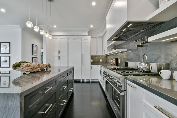 View of the kitchen, featuring white cabinets