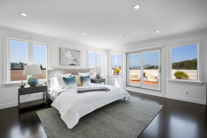 View of a bedroom, featuring wood floors