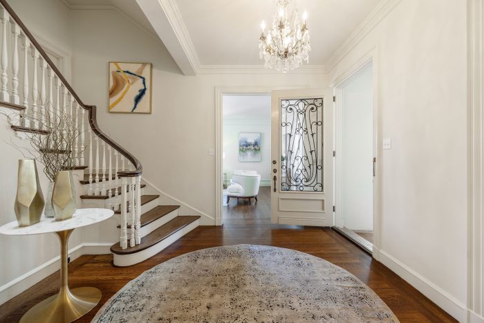 View of a foyer with grand staircase and wood floors