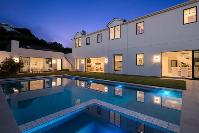 Pool and backyard at twilight.