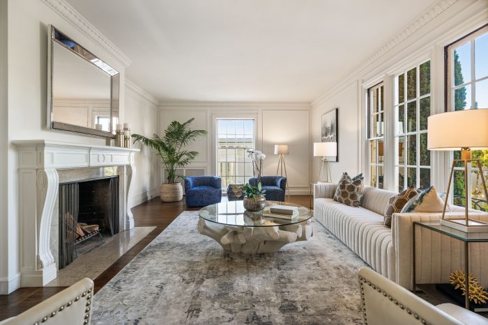 View of a living room with large windows and fireplace