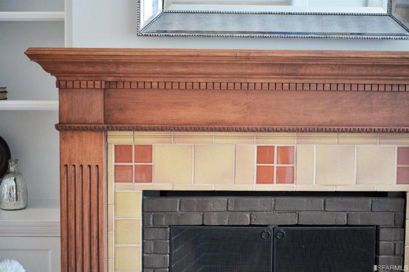 Close-up of a fireplace with wood mantel and frame