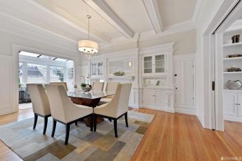 Side-view of the formal dining room featuring white built-in cabinets 