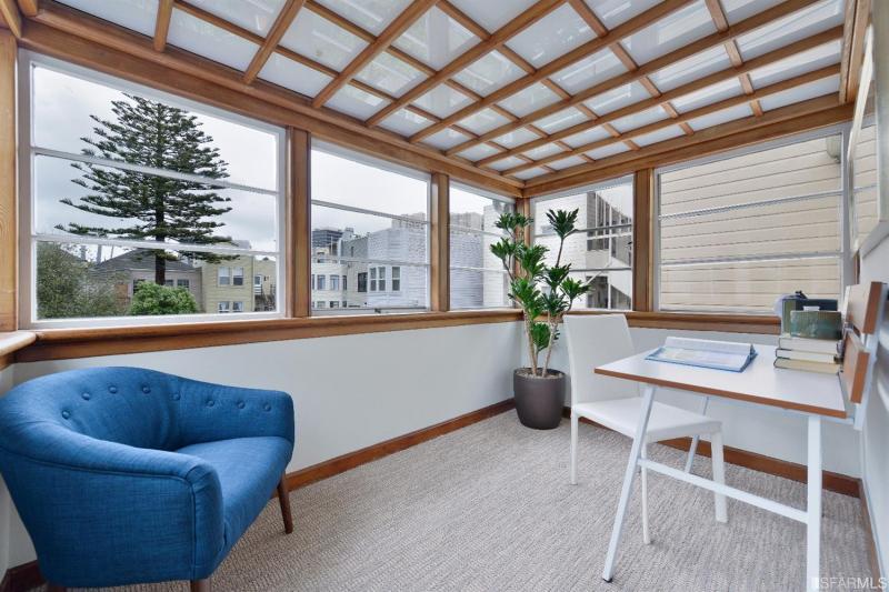 Office area and sunroom with boxed glass ceiling and windows on three sides