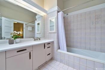 Bathroom, showing cabinets and tiled bath area