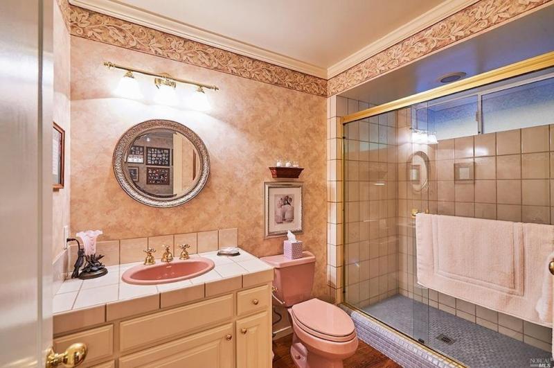 View of a bathroom with sink and pink tile