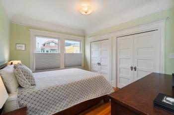 View of a pale green bedroom with large double closets 