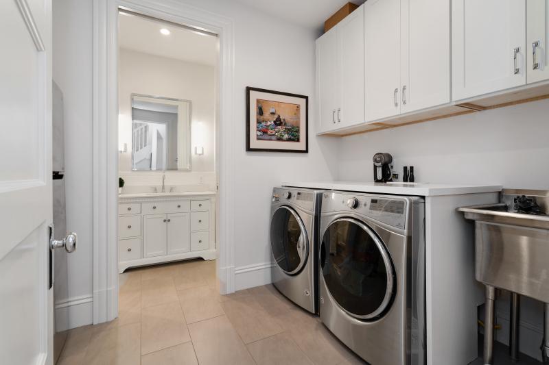 Laundry area with upper cabinetry 