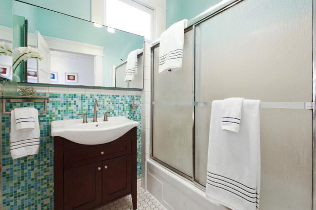 View of a bathroom with teal tile