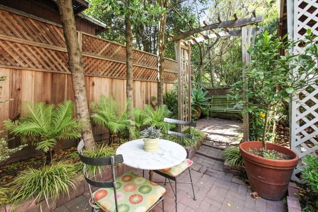 View of plants and wooden archway featured in the back yard