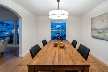 View of the dining area at 1635 40th Avenue, showing a long wood table and wood floors