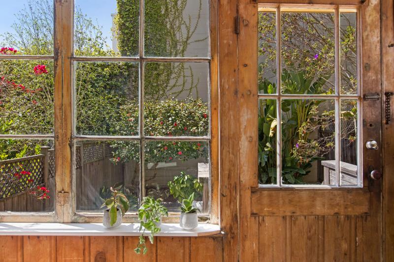 Large windows and a door provide a peek at the back yard of 32 Hartford Street