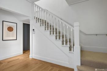 View of a hallway at 2832 Union Street, featuring a white wooden stair rail