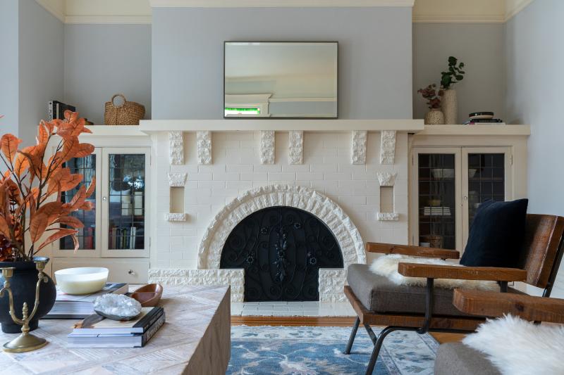An arched, white brick fireplace featured in the living room of 223 Judah Street