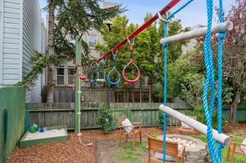 Yard of 223 Judah street featuring a fire pit and play area