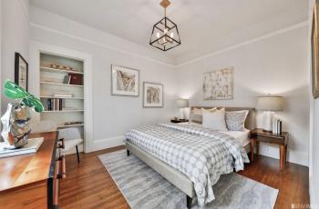 A bedroom at 436 Hugo, featuring wood floors and a built-in shelf 