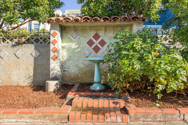 View of the bird pond framed by mediterranean detailing