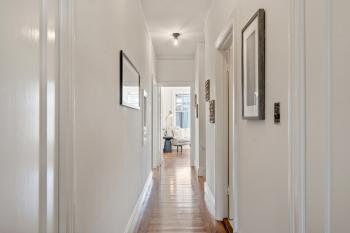 View of the hallway showing wood floors