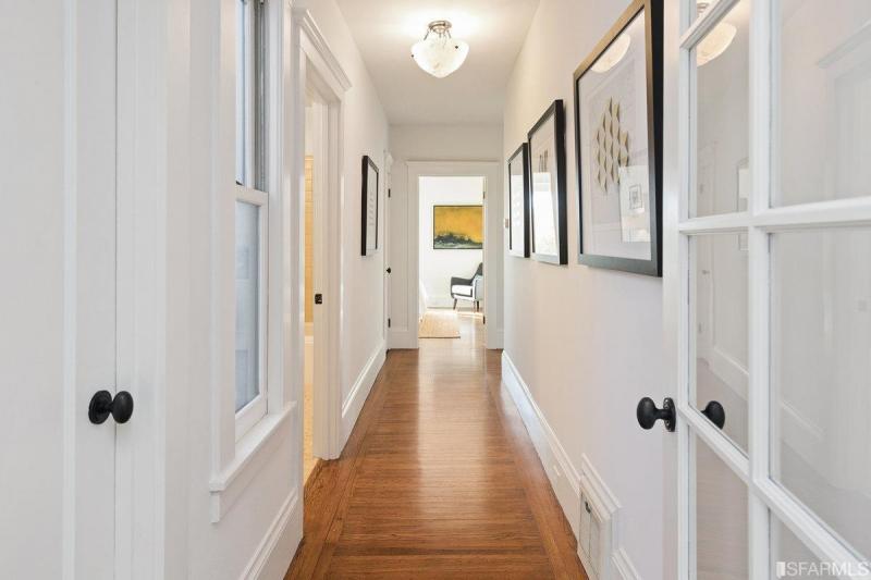 View of a hallway with wood floors
