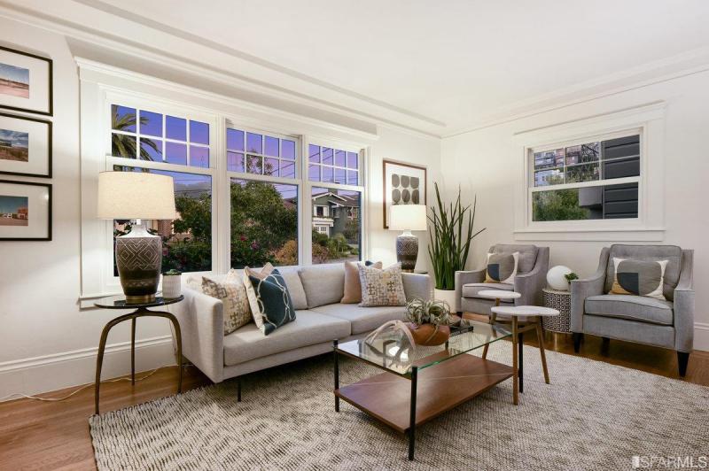 View of the living room with wood floors large windows