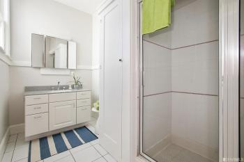 View of a bathroom, with white vanity and shower 