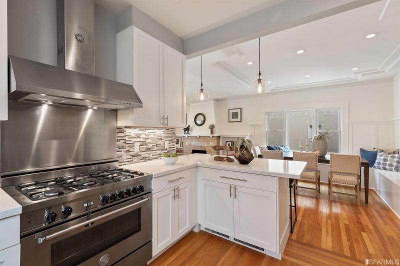 Kitchen with stainless stove and white counters