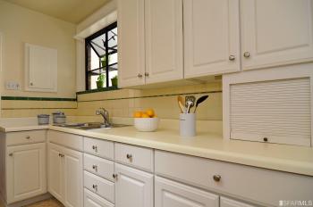 View of the kitchen, featuring white cabinets