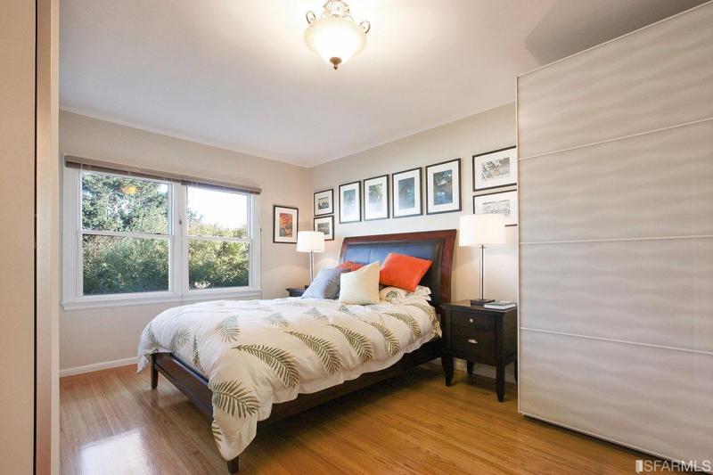View of bedroom one, featuring wood floors