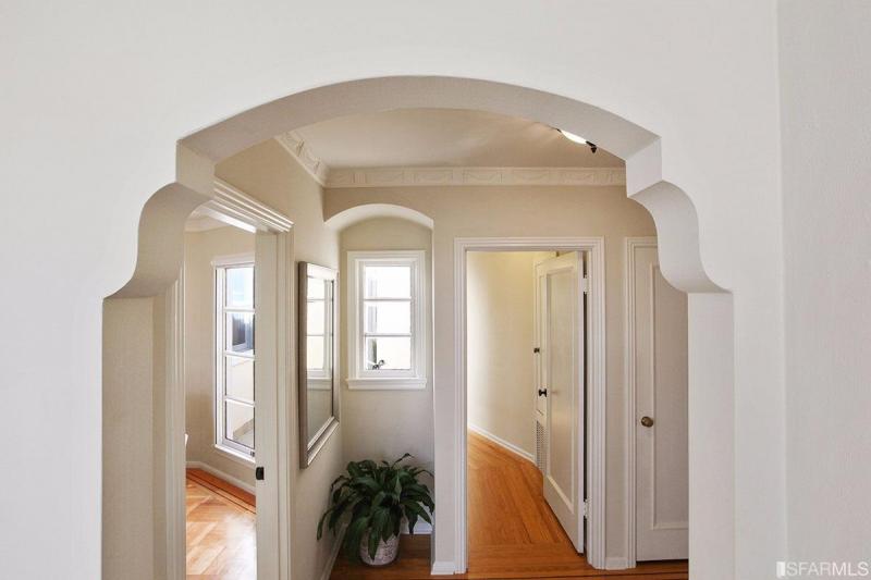 View of the hallway via an arched doorway