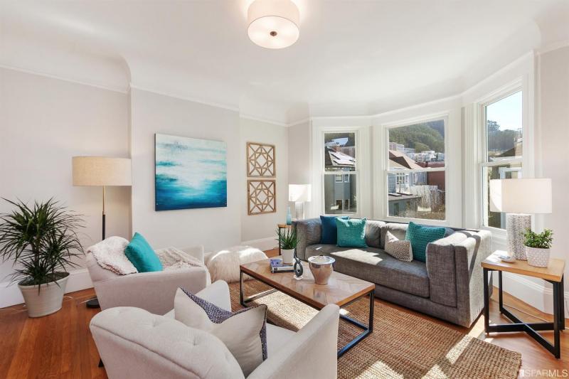 View of the first unit living room, featuring wood floors