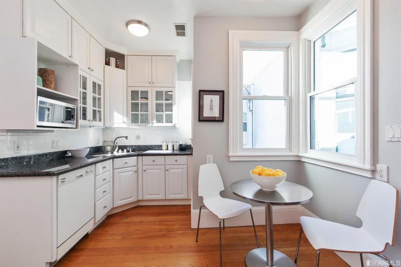 Kitchen for unit one, featuring wood floors