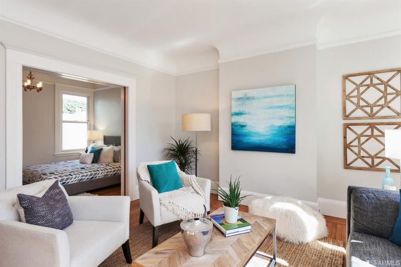 Living room with a view of an adjoining bedroom in unity two